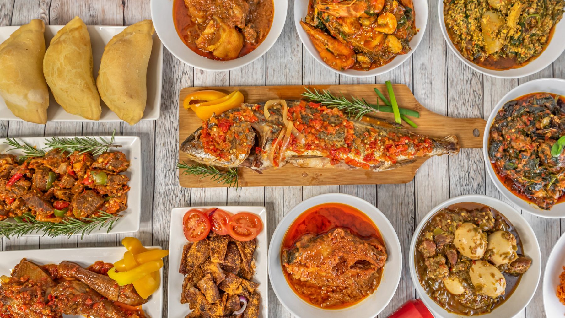 A table spread of Aina's Kitchen West African dishes