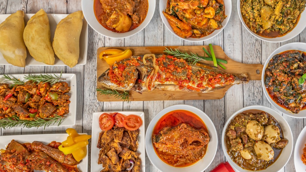 Nigerian feast with jollof rice, grilled chicken, meat pies and pepper stews